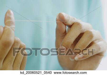 Close up of woman's hands with dental floss View Large Photo Image Stock Image - Close up of woman's hands with dental floss. Fotosearch