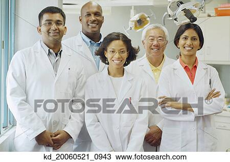 Stock Image - Group of dentists smiling. Fotosearch
