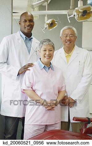 Stock Photograph - Group of dentists smiling. Fotosearch