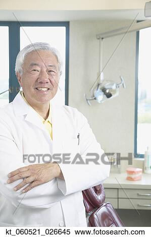 Senior Asian male dentist smiling View Large Photo Image Stock Photography - Senior Asian male dentist smiling. Fotosearch