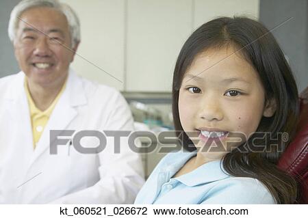 Senior Asian male dentist with young patient View Large Photo Image Stock Image - Senior Asian male dentist with young patient. Fotosearch