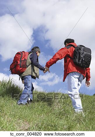 Stock Image - Asian father and son backpacking. Fotosearch