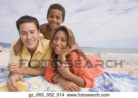 Family lying on the beach View Large Photo Image Picture - Family lying on the beach. Fotosearch