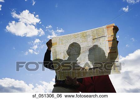 Couple looking at map outdoors View Large Photo Image Stock Photograph - Couple looking at map outdoors. Fotosearch