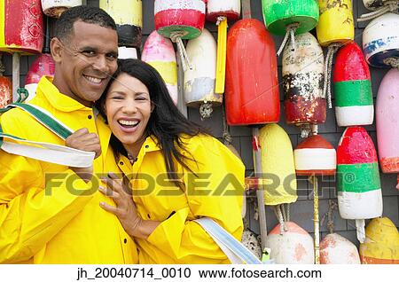 Portrait of a couple standing together smiling View Large Photo Image Stock Image - Portrait of a couple standing together smiling. Fotosearch