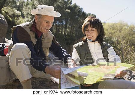 Senior couple looking at map near forest View Large Photo Image Picture - Senior couple looking at map near forest. Fotosearch