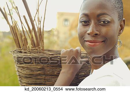 African American woman carrying basket outdoors View Large Photo Image Picture - African American woman carrying basket outdoors. Fotosearch