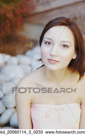 Stock Image - Young woman posing for the camera. Fotosearch