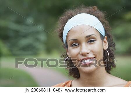 Young woman smiling for the camera View Large Photo Image Stock Photo - Young woman smiling for the camera. Fotosearch