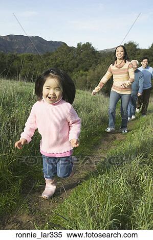 Family playing in a field View Large Photo Image Stock Photography - Family playing in a field. Fotosearch