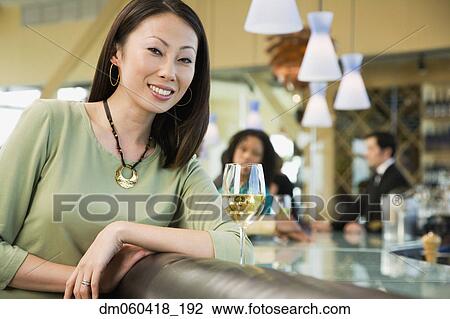 Woman at bar with glass of wine View Large Photo Image Stock Image - Woman at bar with glass of wine. Fotosearch