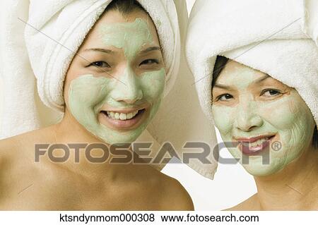 Young woman and her mother smiling for the camera in face masks View Large Photo Image Stock Photo - Young woman and her mother smiling for the camera in face masks. Fotosearch