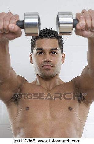 Young man holding dumbbells View Large Photo Image Stock Photography - Young man holding dumbbells. Fotosearch