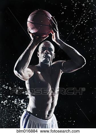 Picture - African American basketball player splashing in water. Fotosearch