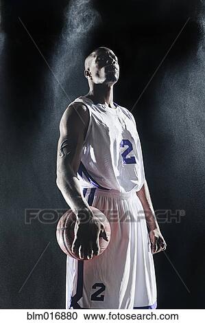 African American basketball player standing under lights View Large Photo Image Stock Image - African American basketball player standing under lights. Fotosearch
