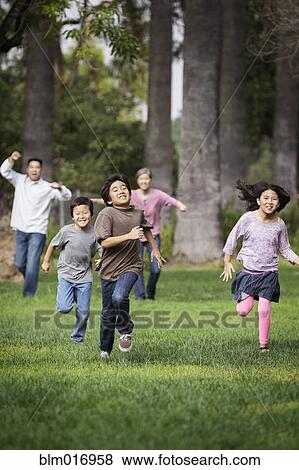Asian family playing together outdoors View Large Photo Image Stock Photo - Asian family playing together outdoors. Fotosearch