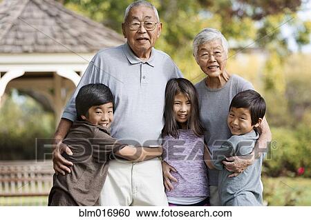 Asian family smiling together outdoors View Large Photo Image Stock Image - Asian family smiling together outdoors. Fotosearch