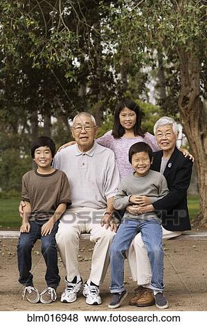 Asian family smiling together outdoors View Large Photo Image Stock Photo - Asian family smiling together outdoors. Fotosearch