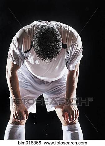 Stock Photography - Asian soccer player resting indoors. Fotosearch