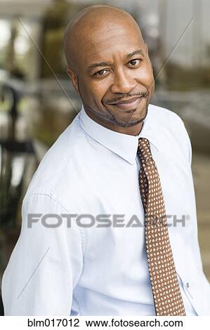 Stock Image - Black businessman smiling. Fotosearch