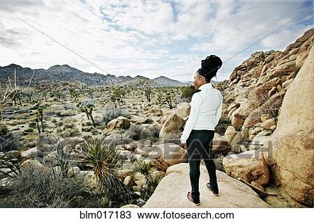 Stock Image - Black runner in desert landscape, Joshua Tree National Park, California, United States. Fotosearch