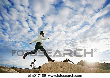 Black runner in desert landscape, Joshua Tree National Park, California, United States View Large Photo Image Stock Photo - Black runner in desert landscape, Joshua Tree National Park, California, United States. Fotosearch