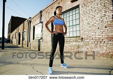 Stock Photo - Black runner standing on city street. Fotosearch