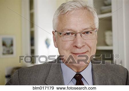 Stock Photo - Businessman smiling in kitchen. Fotosearch