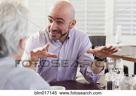 Stock Photography - Businessmen talking in cafe. Fotosearch