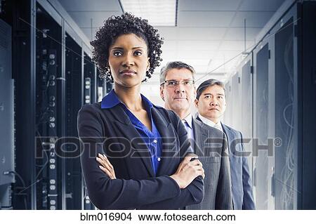 Picture - Businesspeople standing in office. Fotosearch