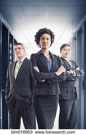 Stock Image - Businesspeople standing in office. Fotosearch