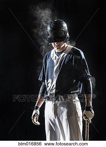 Caucasian baseball player standing under lights View Large Photo Image Stock Photograph - Caucasian baseball player standing under lights. Fotosearch