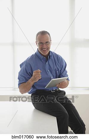 Caucasian businessman using tablet computer View Large Photo Image Stock Image - Caucasian businessman using tablet computer. Fotosearch