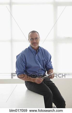 Stock Photo - Caucasian businessman using tablet computer. Fotosearch