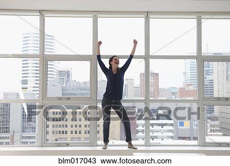 Caucasian businesswoman standing on windowsill View Large Photo Image Stock Image - Caucasian businesswoman standing on windowsill. Fotosearch