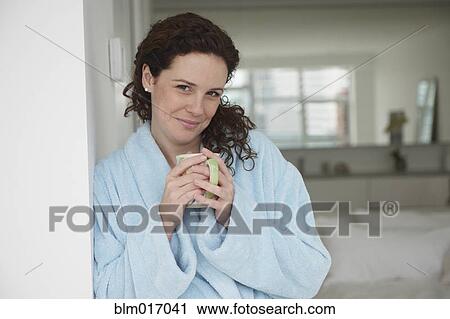 Stock Image - Caucasian woman having cup of coffee. Fotosearch