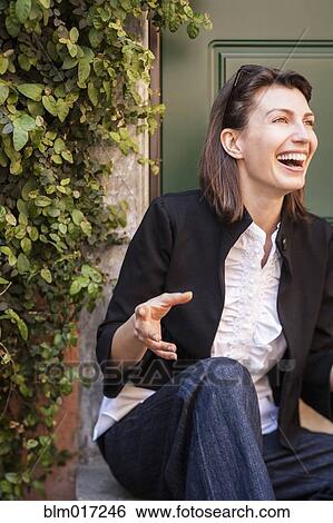 Caucasian woman laughing on front steps View Large Photo Image Stock Photograph - Caucasian woman laughing on front steps. Fotosearch