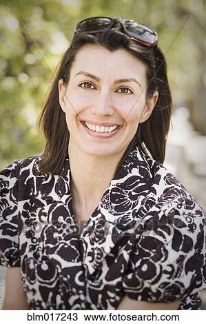 Stock Image - Caucasian woman smiling outdoors. Fotosearch