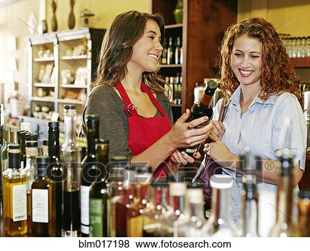 Clerk helping customer in grocery store View Large Photo Image Stock Photo - Clerk helping customer in grocery store. Fotosearch