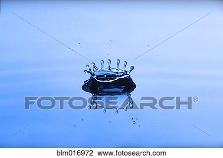 Stock Image - Close up of water droplet splashing. Fotosearch