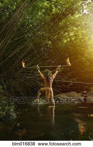 Hawaiian man in traditional outfit holding torch View Large Photo Image Stock Photo - Hawaiian man in traditional outfit holding torch. Fotosearch