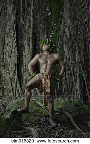 Stock Photo - Hawaiian man wearing traditional outfit in jungle. Fotosearch