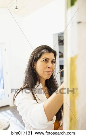 Hispanic artist working in studio View Large Photo Image Stock Image - Hispanic artist working in studio. Fotosearch