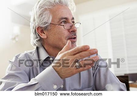 Hispanic businessman gesturing at desk View Large Photo Image Stock Image - Hispanic businessman gesturing at desk. Fotosearch