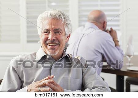 Hispanic businessman laughing in cafe View Large Photo Image Stock Image - Hispanic businessman laughing in cafe. Fotosearch