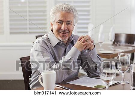 Hispanic businessman smiling in cafe View Large Photo Image Stock Image - Hispanic businessman smiling in cafe. Fotosearch