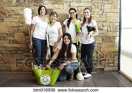 Stock Photograph - Hispanic cleaning crew smiling together. Fotosearch