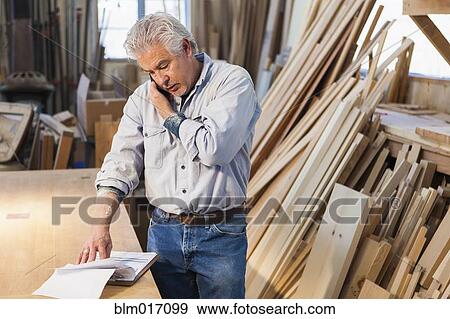 Stock Photo - Hispanic craftsman working in studio. Fotosearch