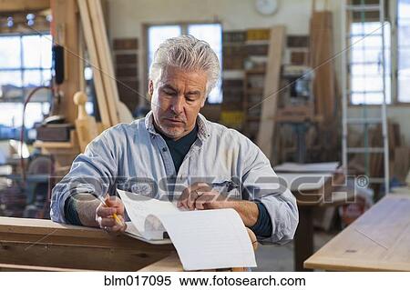 Stock Photography - Hispanic craftsman working in studio. Fotosearch