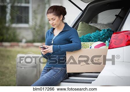 Stock Photograph - Hispanic girl packing for college. Fotosearch